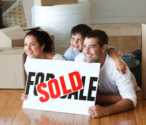 Happy family with sold sign